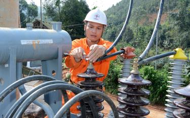 A worker examines a new transformer station.